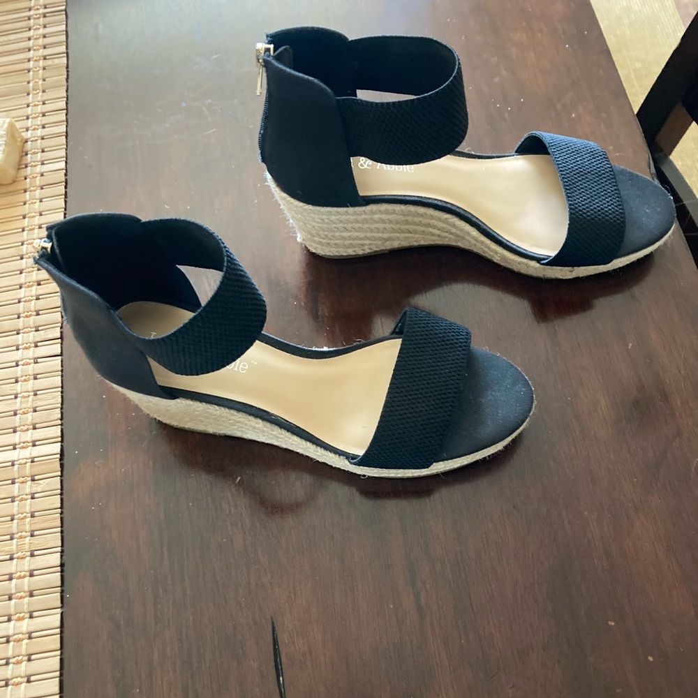 Black wedge sandals with a zip in the back as closure and new with tag.